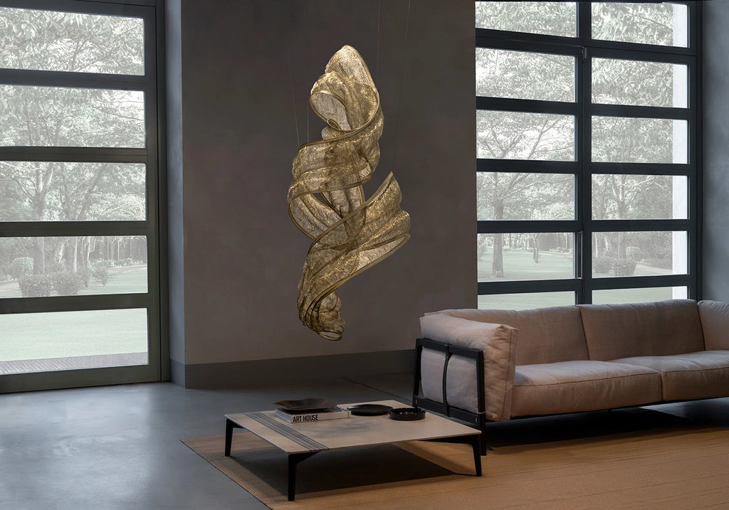 Genesis Vertical Floating Knit Sculpture by Terzani in brass, suspended in a contemporary living room.